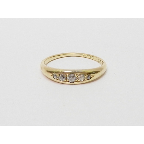 24 - An 18ct gold five stone diamond ring, the graduated stones pave set in a boat shaped head.  Central ... 
