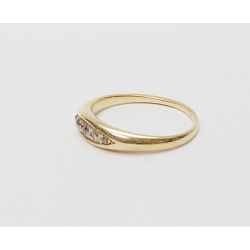 24 - An 18ct gold five stone diamond ring, the graduated stones pave set in a boat shaped head.  Central ... 