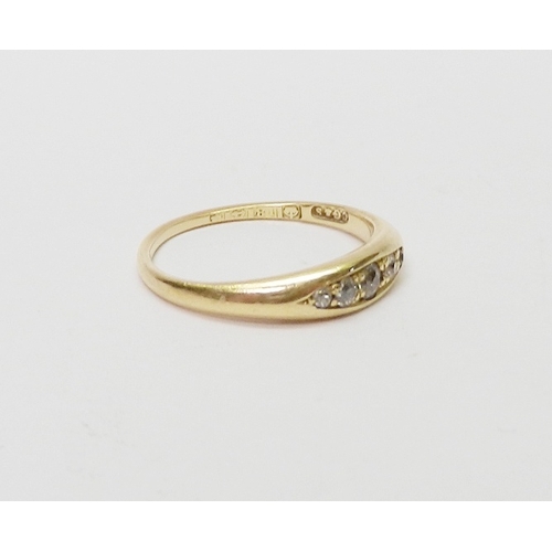 24 - An 18ct gold five stone diamond ring, the graduated stones pave set in a boat shaped head.  Central ... 