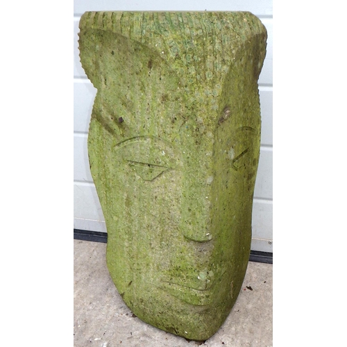 A carved stone head, 55cm tall