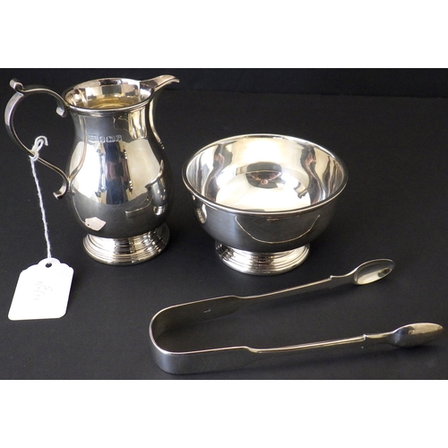 A silver jug with matching bowl, Roberts & Belk Sheffield 1980; a pair of Victorian silver sugar tongs.  Bowl 100mm diameter / 450g