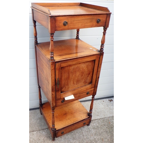 A Regency mahogany whatnot with cupboard to the centre and drawers, 52cm wide, split to side