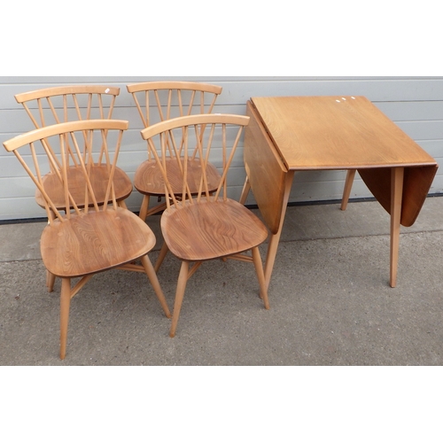 835 - A blonde Ercol drop leaf dining table together with four crossover spindle back chairs, fading & mar...