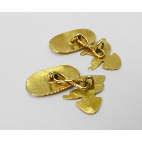 64 - A pair of chain link cufflinks comprising an elephant and palm tree motif head and a plain oval back... 