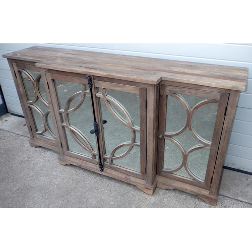 642 - An Oka rustic breakfront cabinet with mirrored doors, 200cm wide