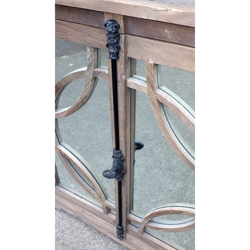 642 - An Oka rustic breakfront cabinet with mirrored doors, 200cm wide