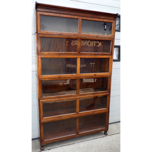 A large oak six section bookcase, 128cm wide