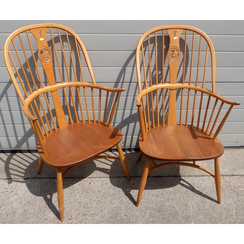A pair of blonde Ercol Windsor chairs with swan splat backs