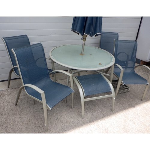 678 - An aluminum framed glass topped circular garden table with umbrella, base, four stacking chairs & fo... 
