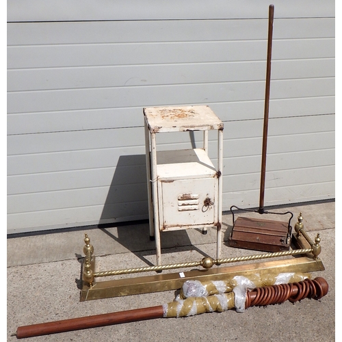 676 - A metal cupboard, push hoover, curtain rail and brass fire curb