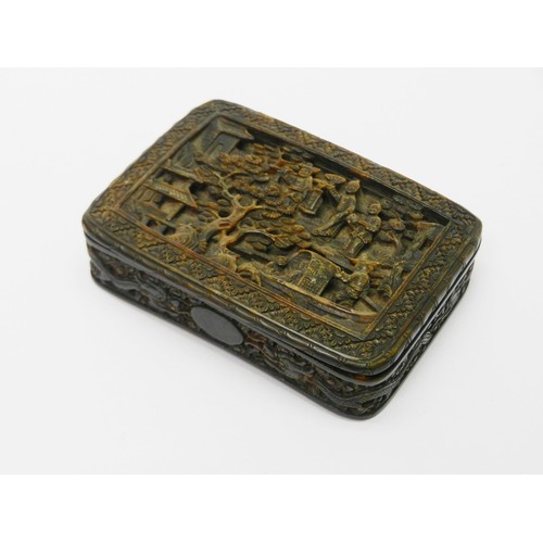 A Chinese 19th cent curved rectangular tortoiseshell snuff box having a hinged lid, the exterior heavily carved with idealised landscape scenes to front and back incorporating travellers, boats, buildings etc and the sides comprising a dragon motif frieze.  91 x 66mm