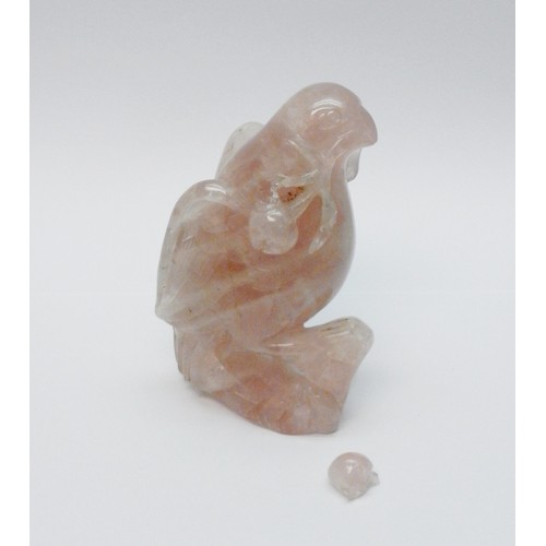 A Chinese figurine depicting a bird with fruit, carved pink fluorite, a/f.  150mm tall