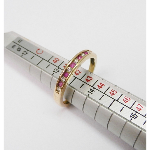 A half hoop ring comprising six round cut diamonds and five round cut rubies channel set in a 9ct gold shank.  2.5mm wide / approx 2g gross / size R.  Boxed