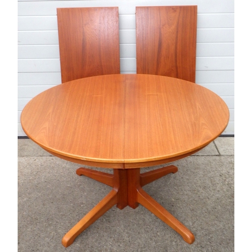 A teak dining table with two leaves, 220cm long extended