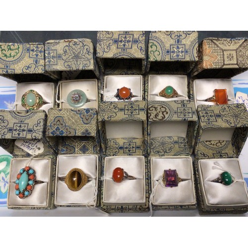 227 - Ten Chinese cocktail rings: variously stone set white metal / gilt white metal. All boxed, unused.
