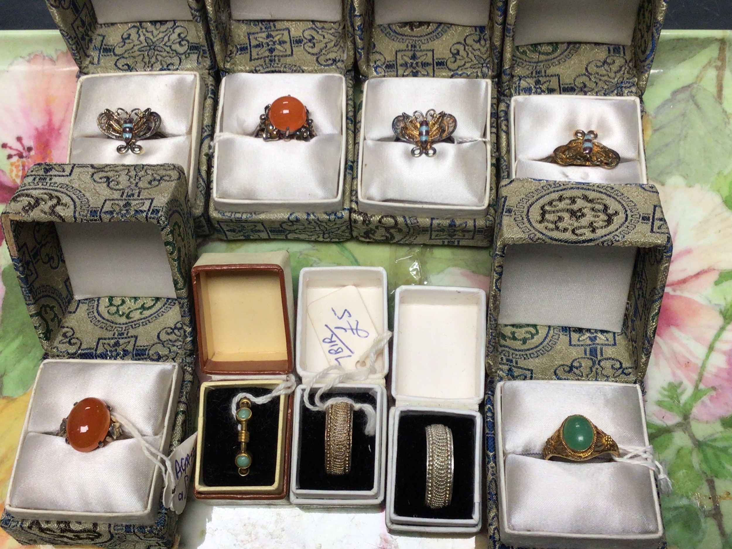 Ten Chinese cocktail rings: variously stone set white metal / gilt ...
