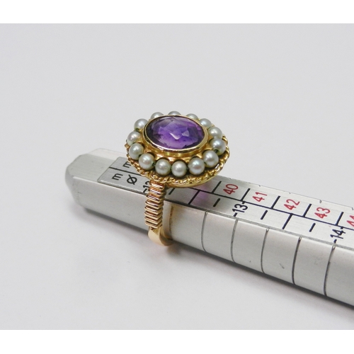 40 - A Georgian style cluster ring comprising a central amethyst surrounded by a halo of strung pearls in... 