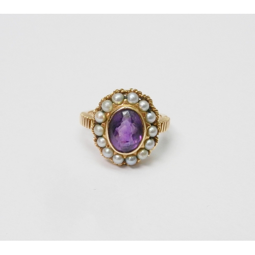 40 - A Georgian style cluster ring comprising a central amethyst surrounded by a halo of strung pearls in... 