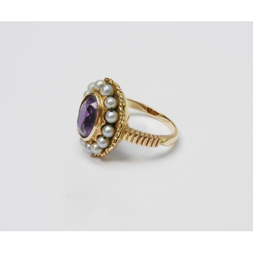 40 - A Georgian style cluster ring comprising a central amethyst surrounded by a halo of strung pearls in... 
