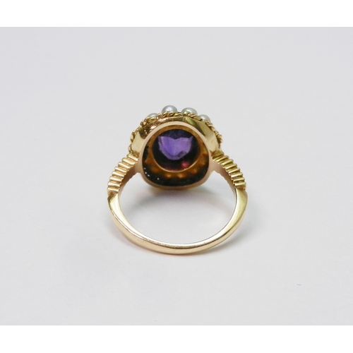 40 - A Georgian style cluster ring comprising a central amethyst surrounded by a halo of strung pearls in... 