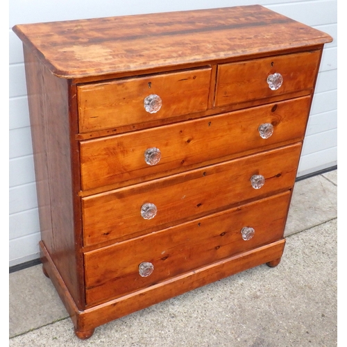 614 - A stained pine chest of drawers, with glass handles, 101cm wide