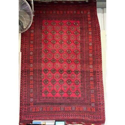 615 - A red ground Bokhara style rug 130 x 200cm