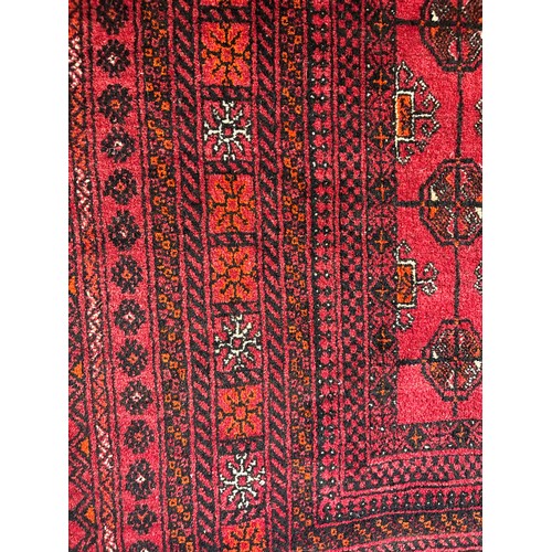615 - A red ground Bokhara style rug 130 x 200cm
