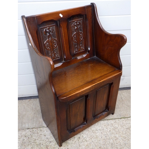 637 - A panelled oak hall settle, 55cm wide