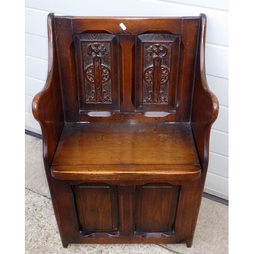 637 - A panelled oak hall settle, 55cm wide