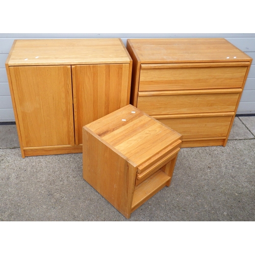 638 - A modern light oak chest of drawers with matching cupboard and bedside chest, marks (3)