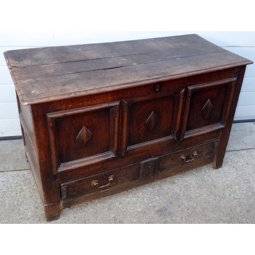 656 - A three panel oak coffer with lower drawer, 122cm wide (a/f)