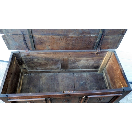656 - A three panel oak coffer with lower drawer, 122cm wide (a/f)