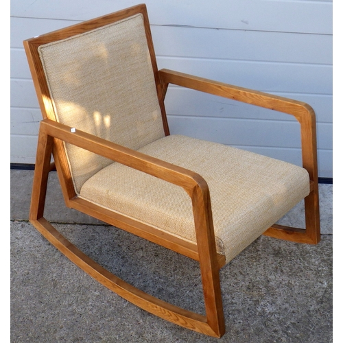 664 - A modern oak rocking chair with label, 