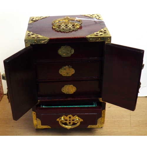 40 - A boxed hardwood soapstone inlaid jewellery cabinet, 22cm tall