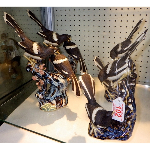 102 - Four Chinese ceramic figures of Magpies on branches, 26cm tall (4)