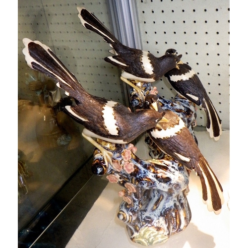 102 - Four Chinese ceramic figures of Magpies on branches, 26cm tall (4)