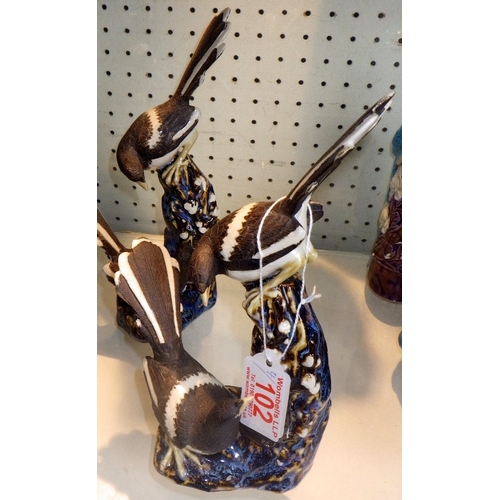 102 - Four Chinese ceramic figures of Magpies on branches, 26cm tall (4)