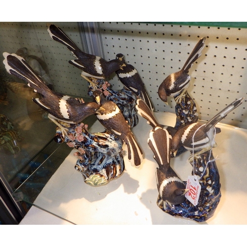 102 - Four Chinese ceramic figures of Magpies on branches, 26cm tall (4)