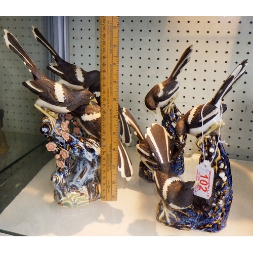 102 - Four Chinese ceramic figures of Magpies on branches, 26cm tall (4)