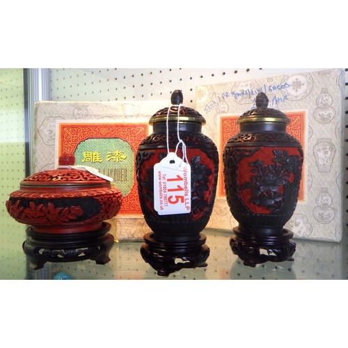 115 - A pair of Chinese Black & Red Cinnabar vases with blue enamel interior together with a similar lidde... 