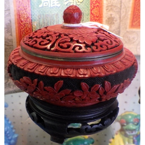 115 - A pair of Chinese Black & Red Cinnabar vases with blue enamel interior together with a similar lidde... 