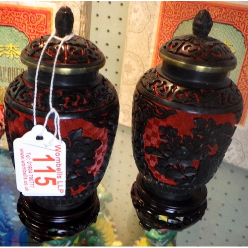 115 - A pair of Chinese Black & Red Cinnabar vases with blue enamel interior together with a similar lidde... 