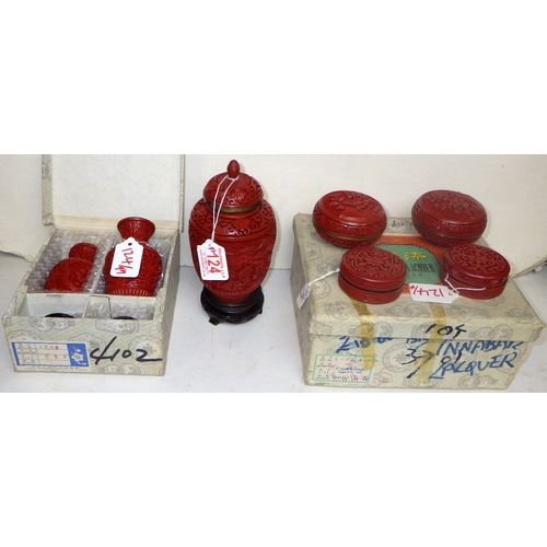 124 - A group of Chinese Red Cinnabar trinket boxes, a pair of vases and a lidded urn with blue enamel int... 