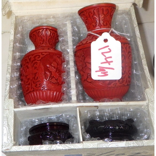 124 - A group of Chinese Red Cinnabar trinket boxes, a pair of vases and a lidded urn with blue enamel int... 