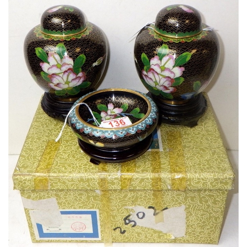 136 - A pair of cloisonné floral ginger jars, 17cm tall, and matching bowl