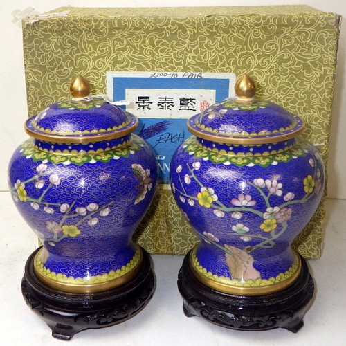 141 - A pair of cloisonné floral lidded urns, 19cm tall