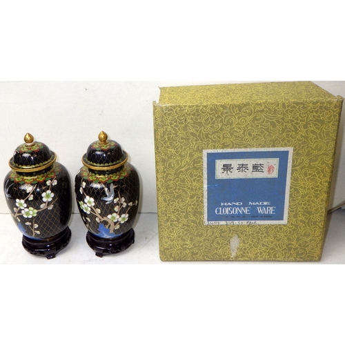 150 - A pair of floral cloisonné lidded urns, 19cm tall