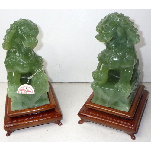 190 - A pair of circa 1960s / 1970s Chinese jade carved Dogs of Foo figures on wooden stands
