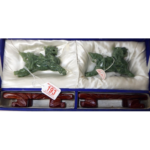 193 - A pair of circa 1960s / 1970s Chinese jade carved beast figures on wooden stands
