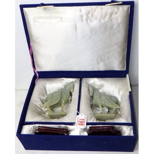 198 - A pair of circa 1960s / 1970s Chinese jade carved warhorses on wooden stands